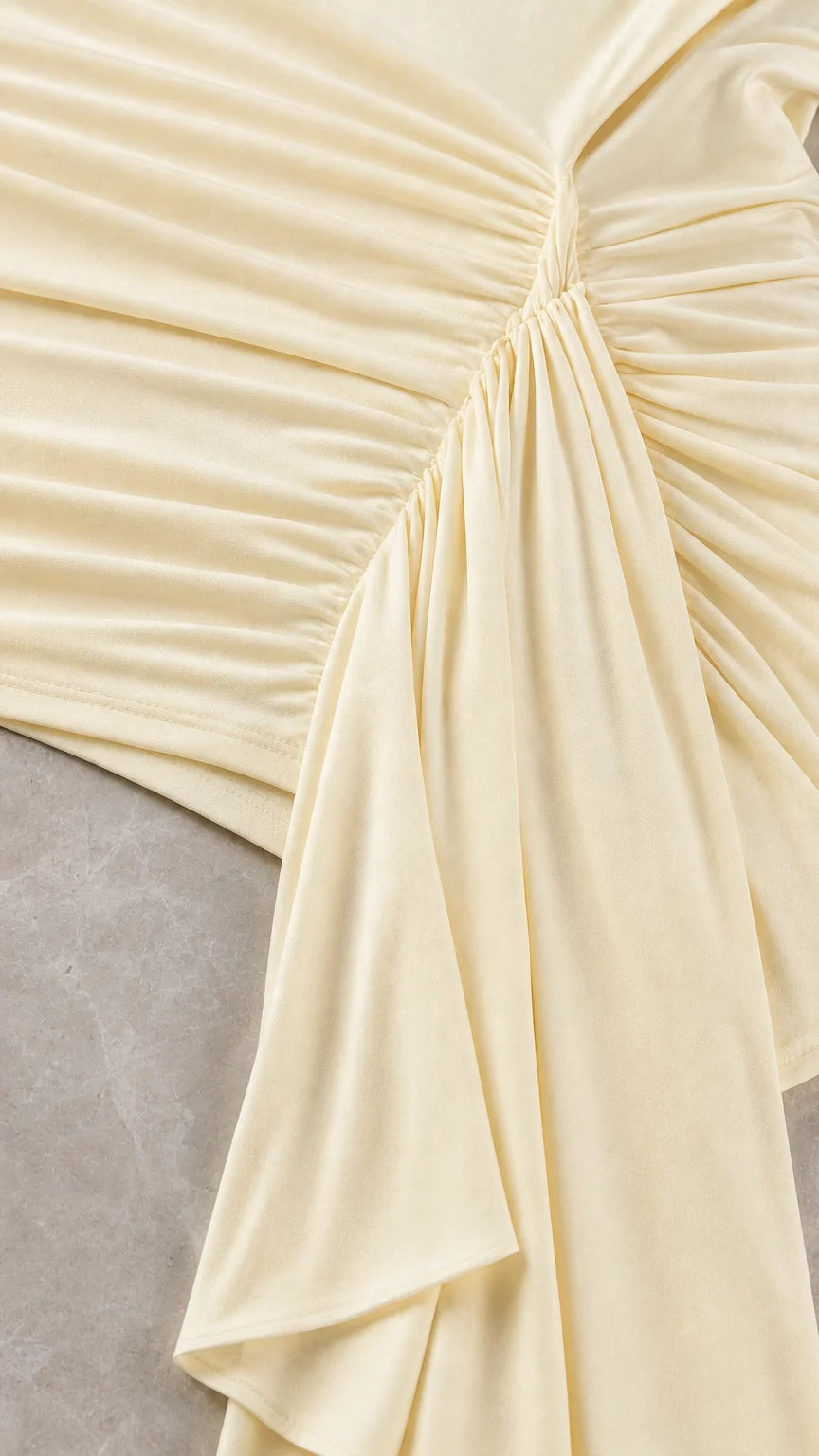 Close up of ruching and fabric detail on champagne dress