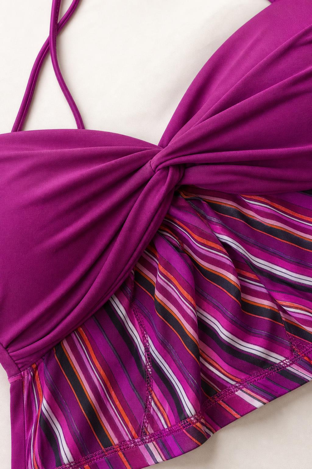 Close-up detail of magenta twist-front crop top and stripes