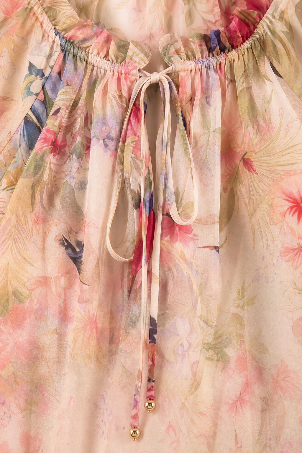 Close-up of gathered neckline and tie strings with metal accents