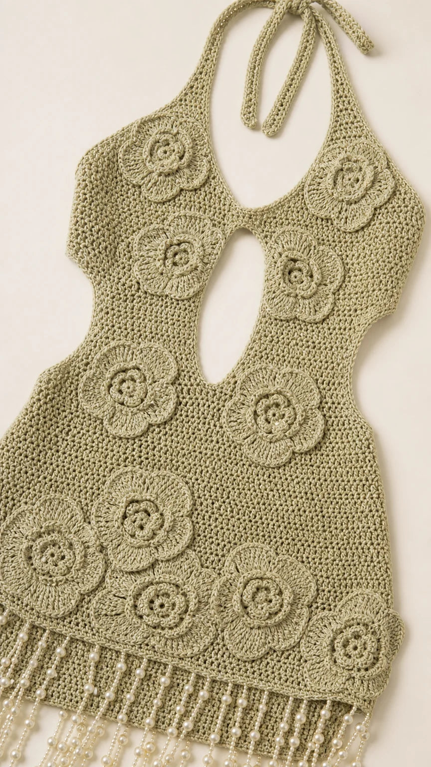 Close up of crochet floral pattern and beaded fringe hem