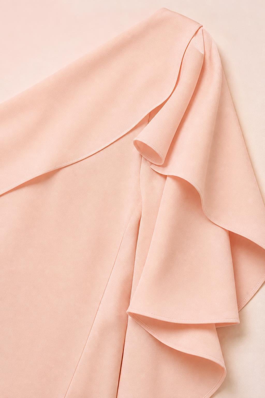 Close-up detail of the layered ruffle sleeve on the peach dress