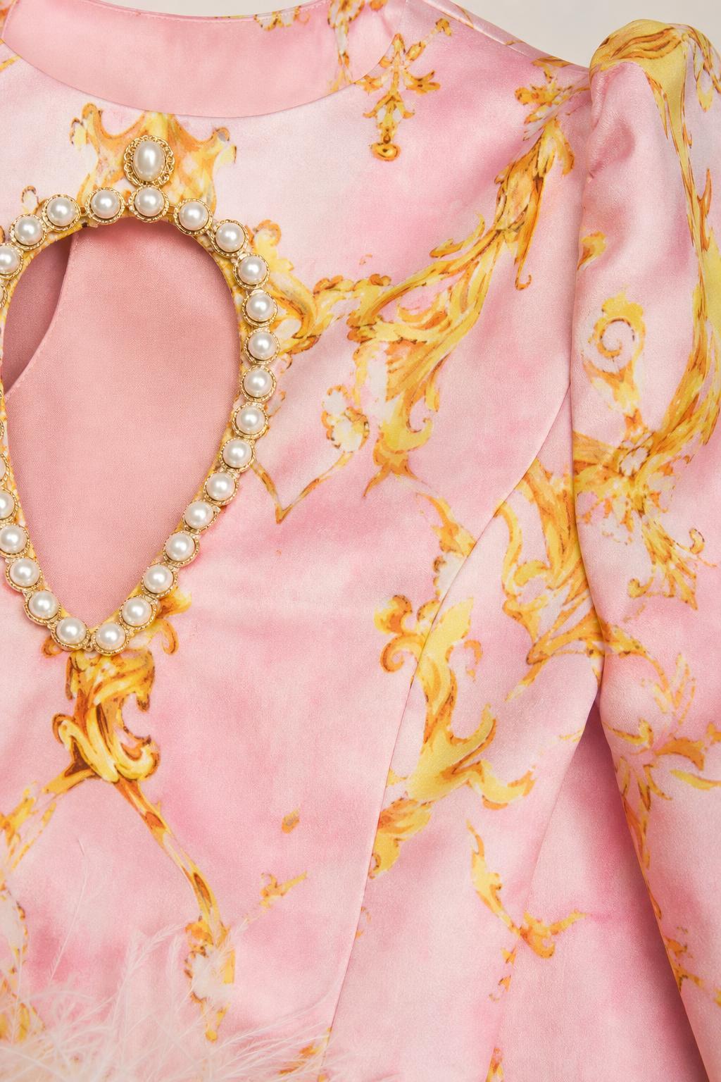 Close up of pearl-trimmed keyhole detail on the neckline