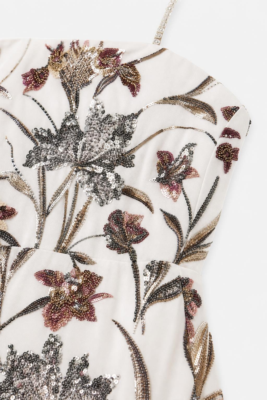 Close-up detail of intricate floral beadwork and sequin embroidery