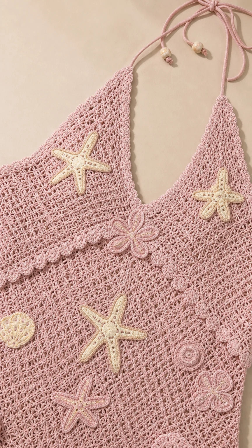 Close-up of pink crochet fabric and starfish appliqués