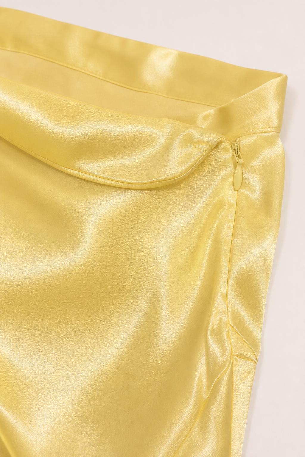 Close-up of yellow satin fabric and side zipper detail