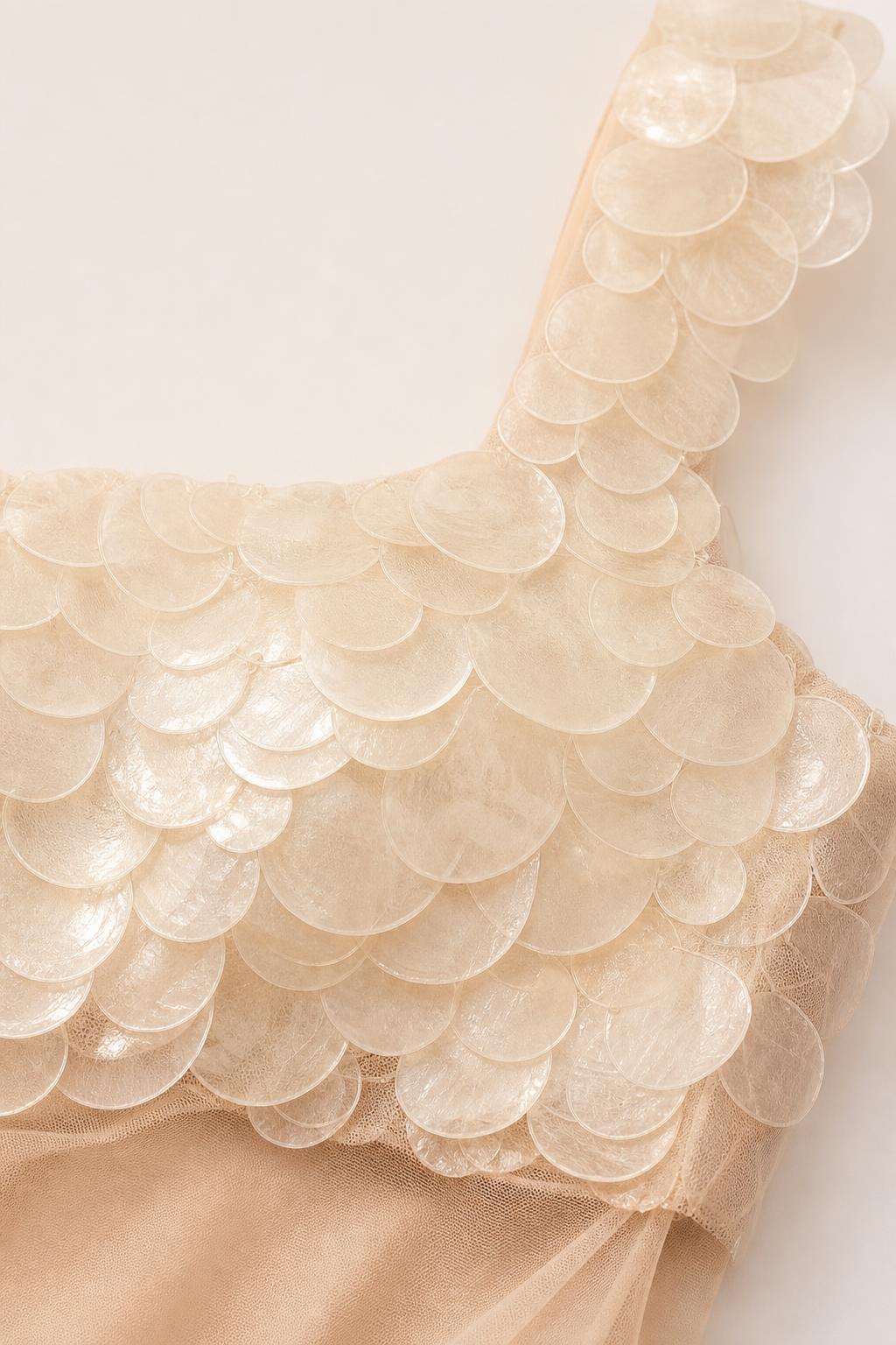 Close-up detail of circular textured appliques on the bodice