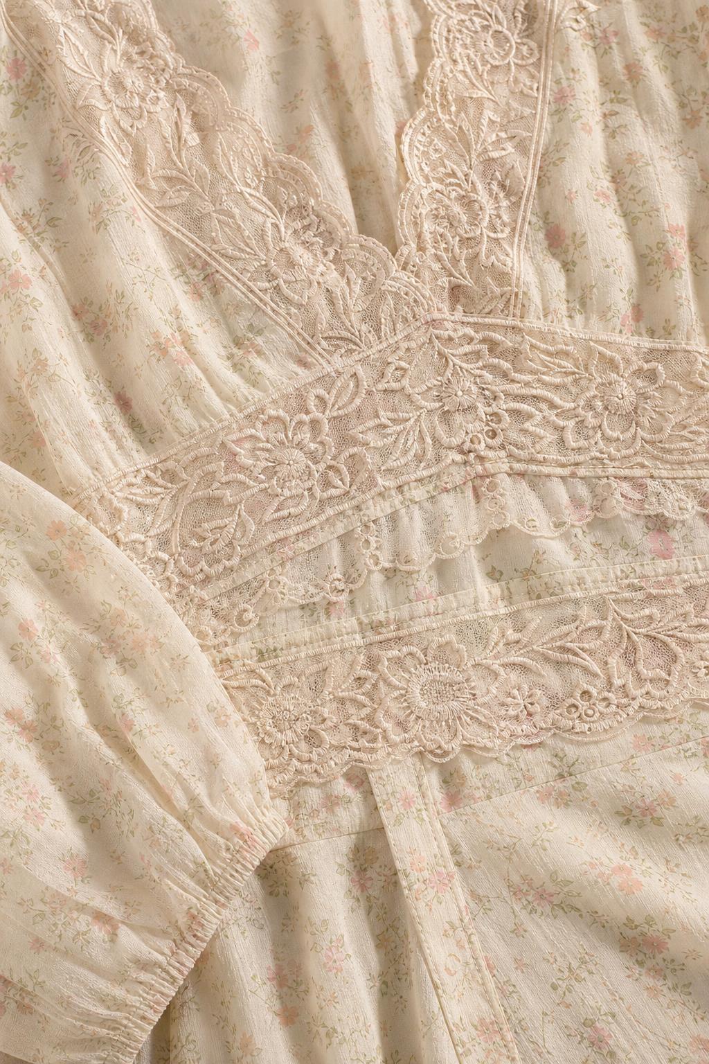 Close-up detail of bodice with lace inserts and floral pattern