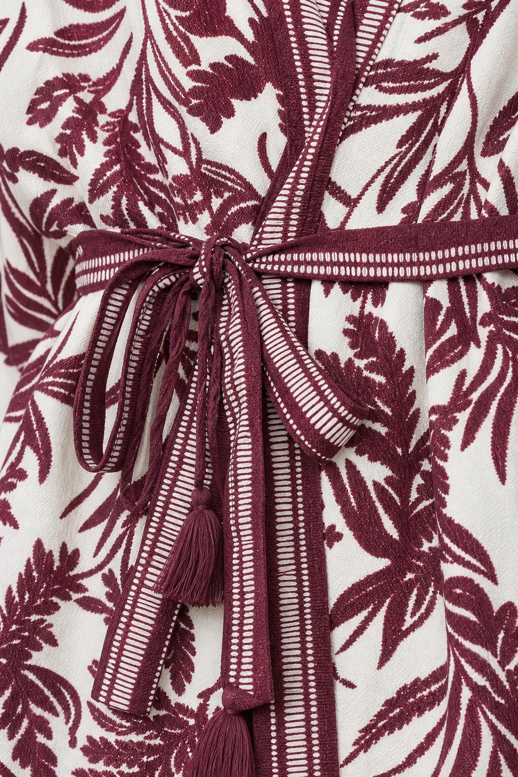 Close up of self-tie belt and fabric detail on jumpsuit
