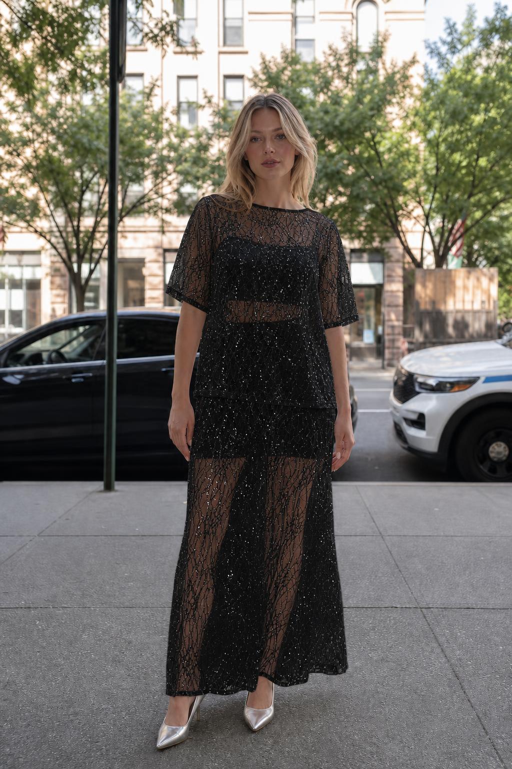 Woman wearing black sheer sequin lace two-piece set