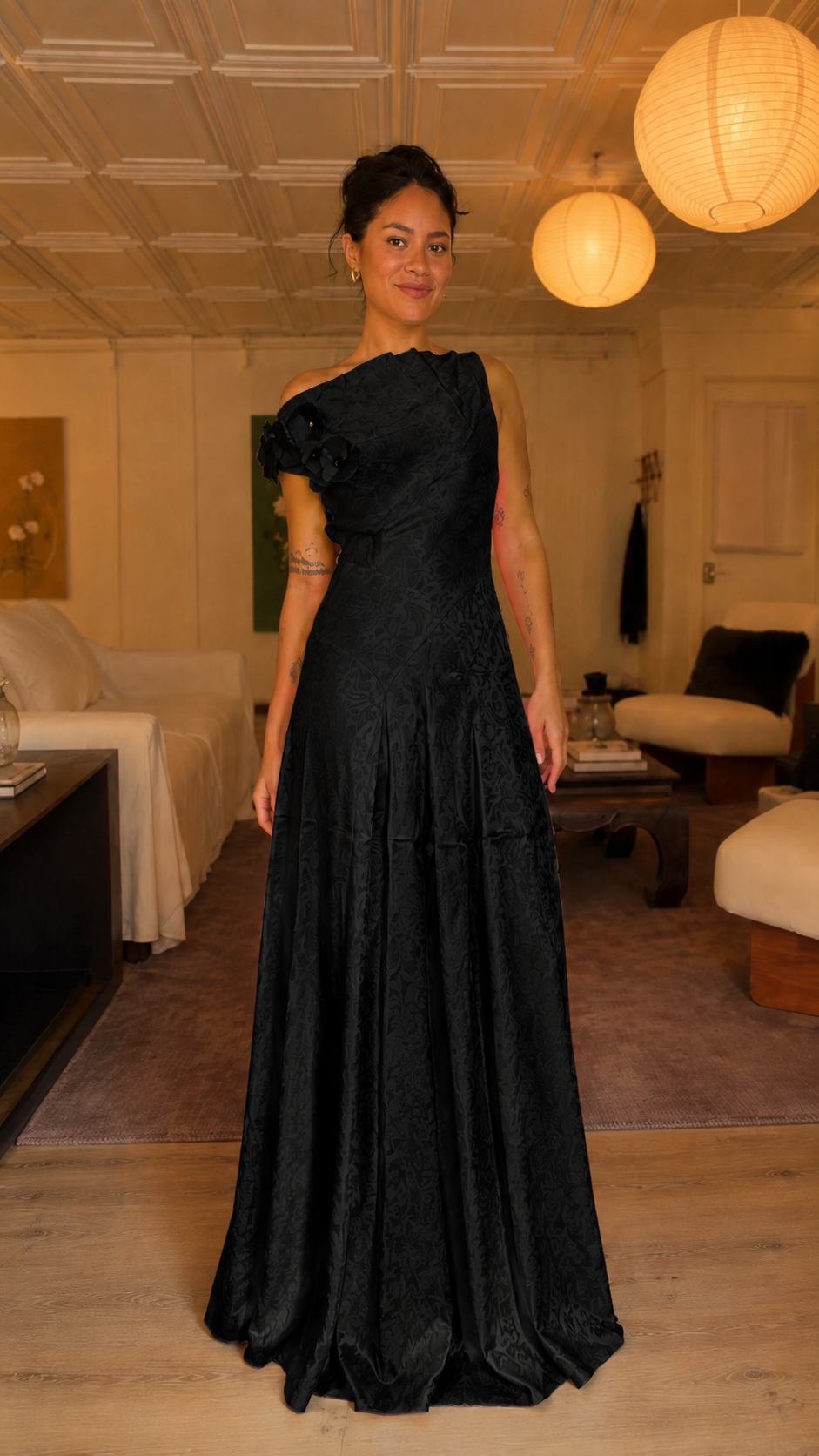 Front view of black one-shoulder floral appliqué evening gown
