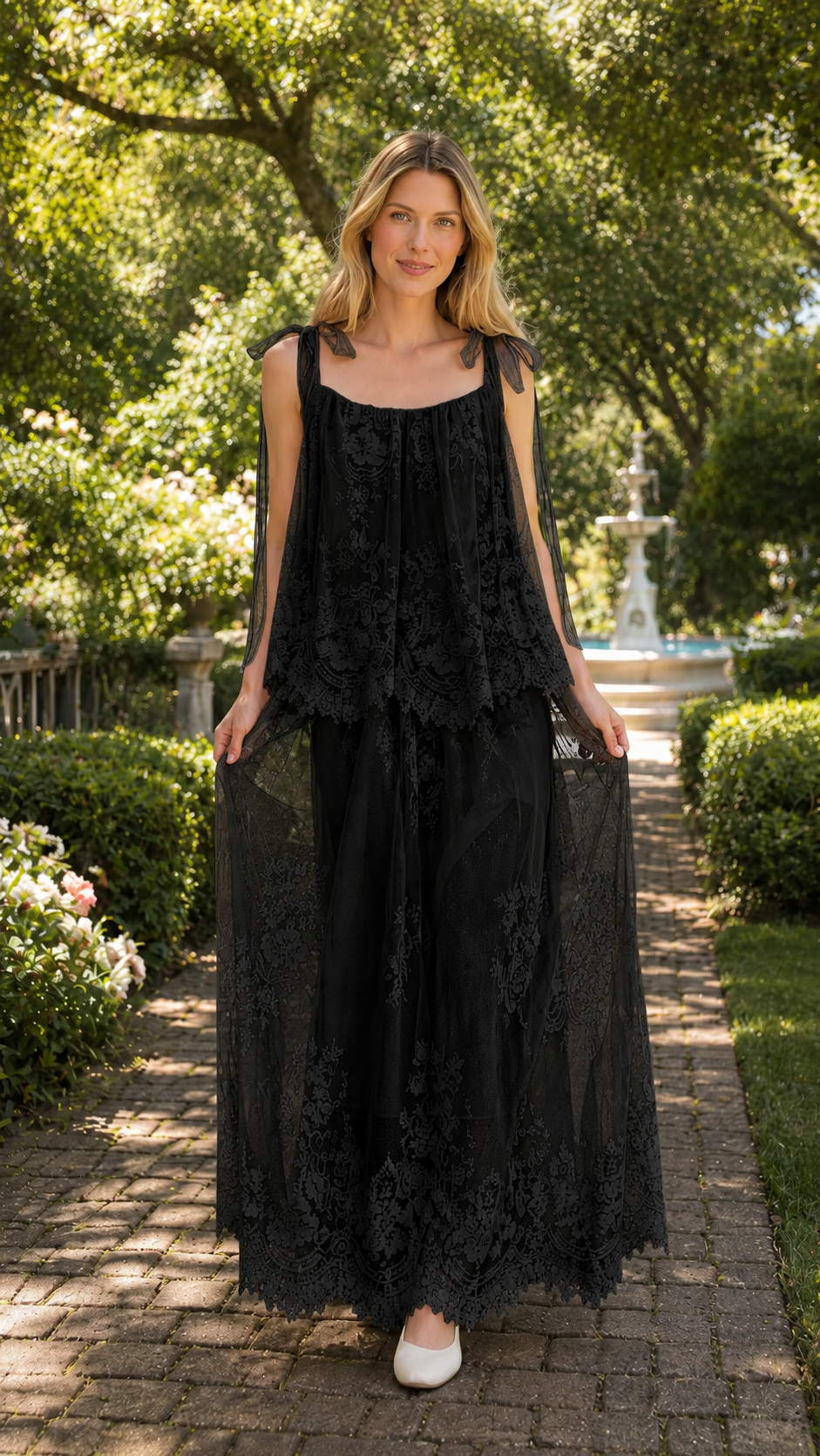Front view of black tie-shoulder lace overlay maxi dress with sheer layered skirt