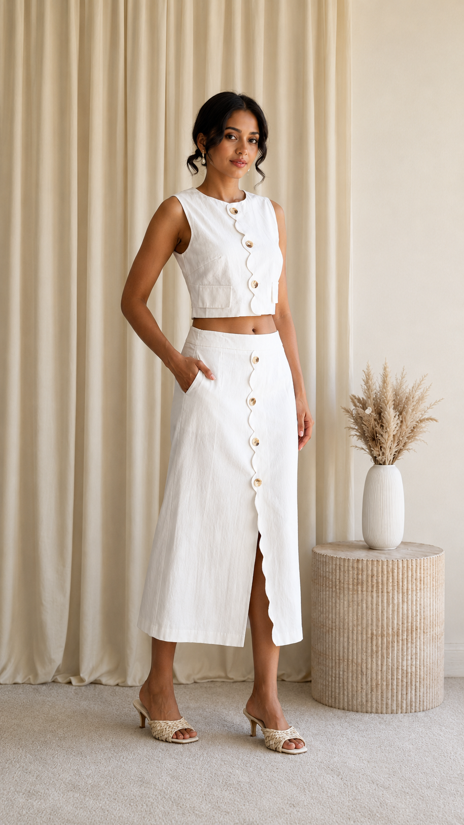 Angled front view of white sleeveless crop top and midi skirt set
