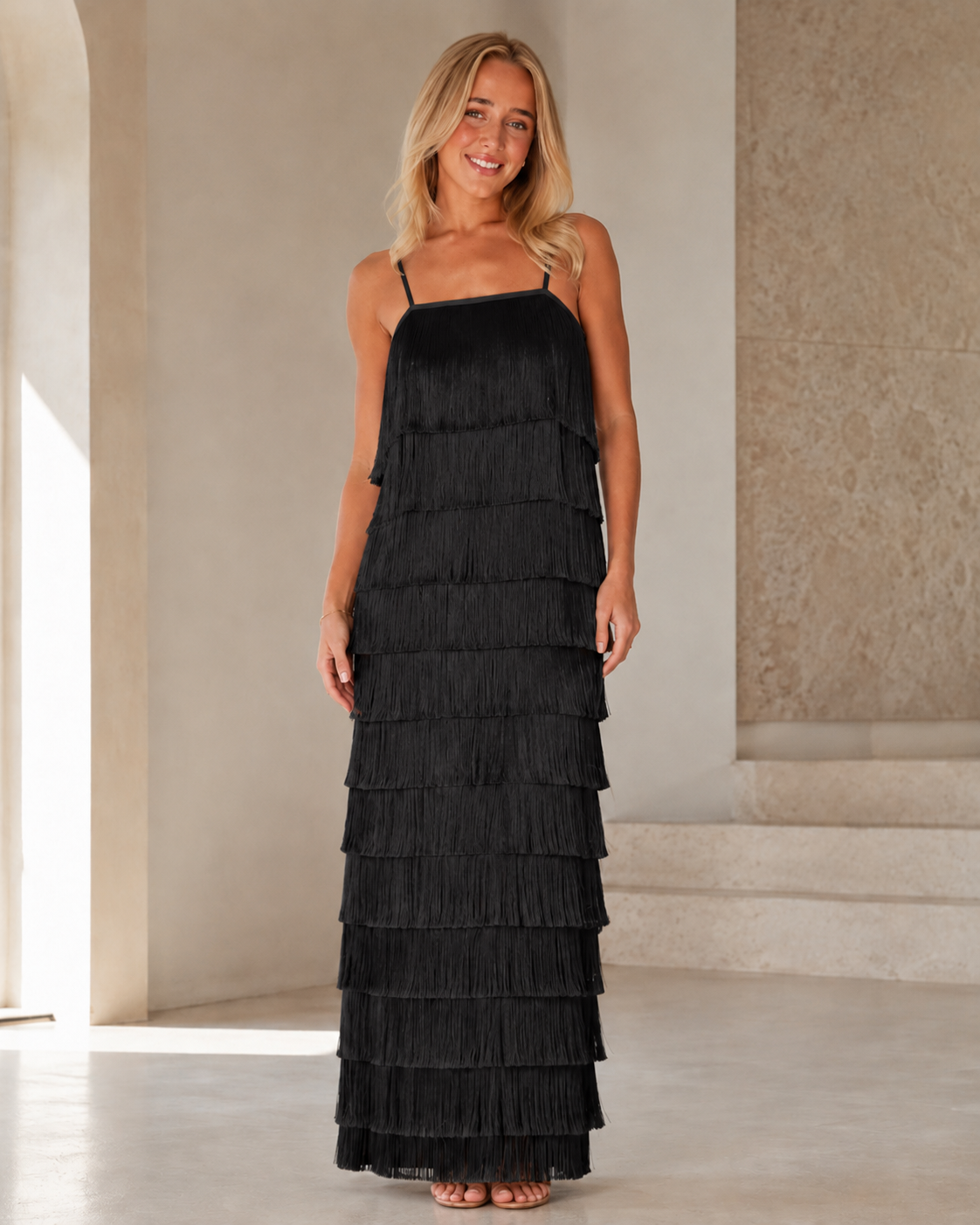 Full front view of black tiered fringe maxi dress with cami straps