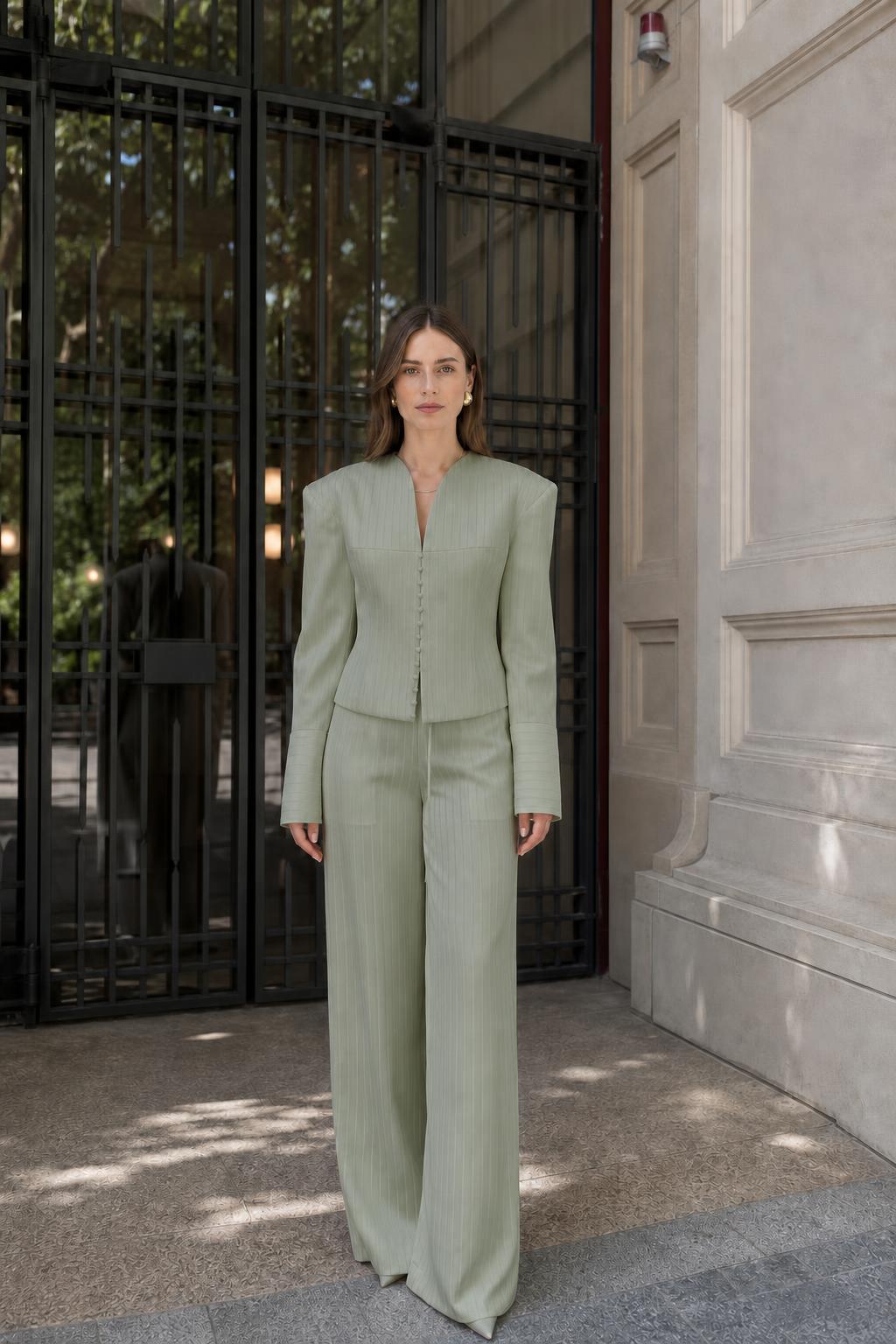 Model wearing sage green pinstripe suit