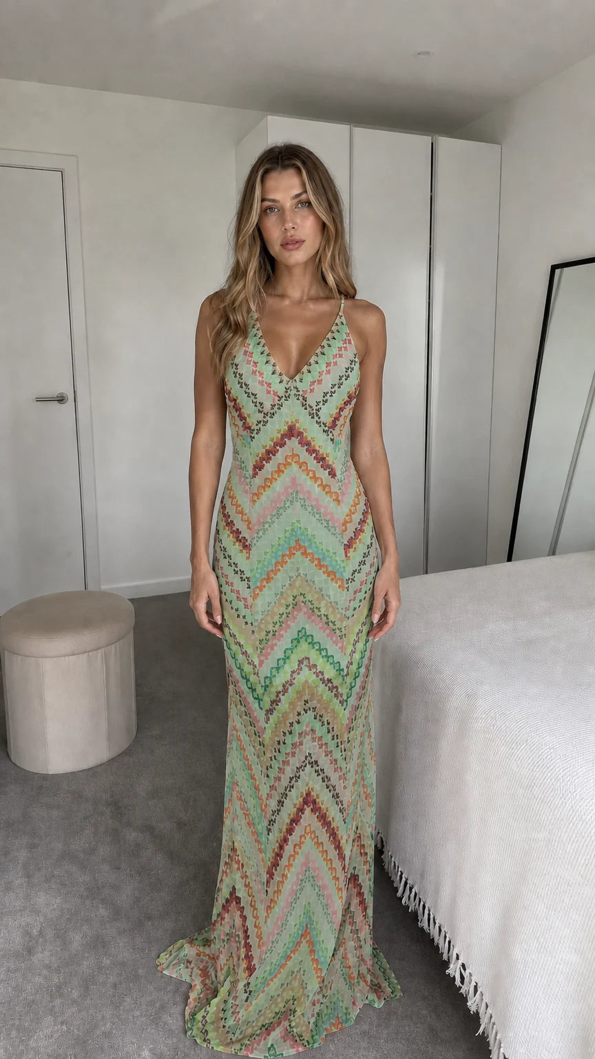 Front view of model wearing sage green chevron maxi dress