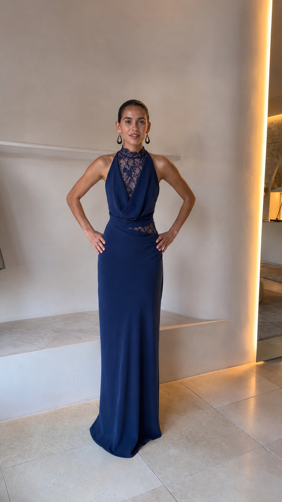 Front view of navy blue halter lace formal gown with draped neckline