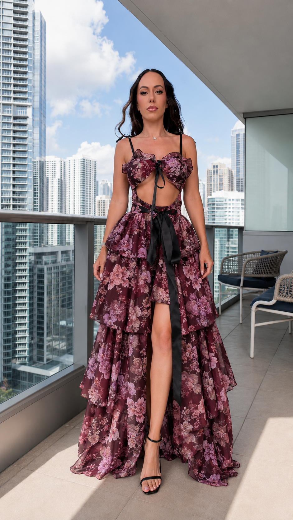 Front view of burgundy floral tiered maxi dress with black tie and front slit