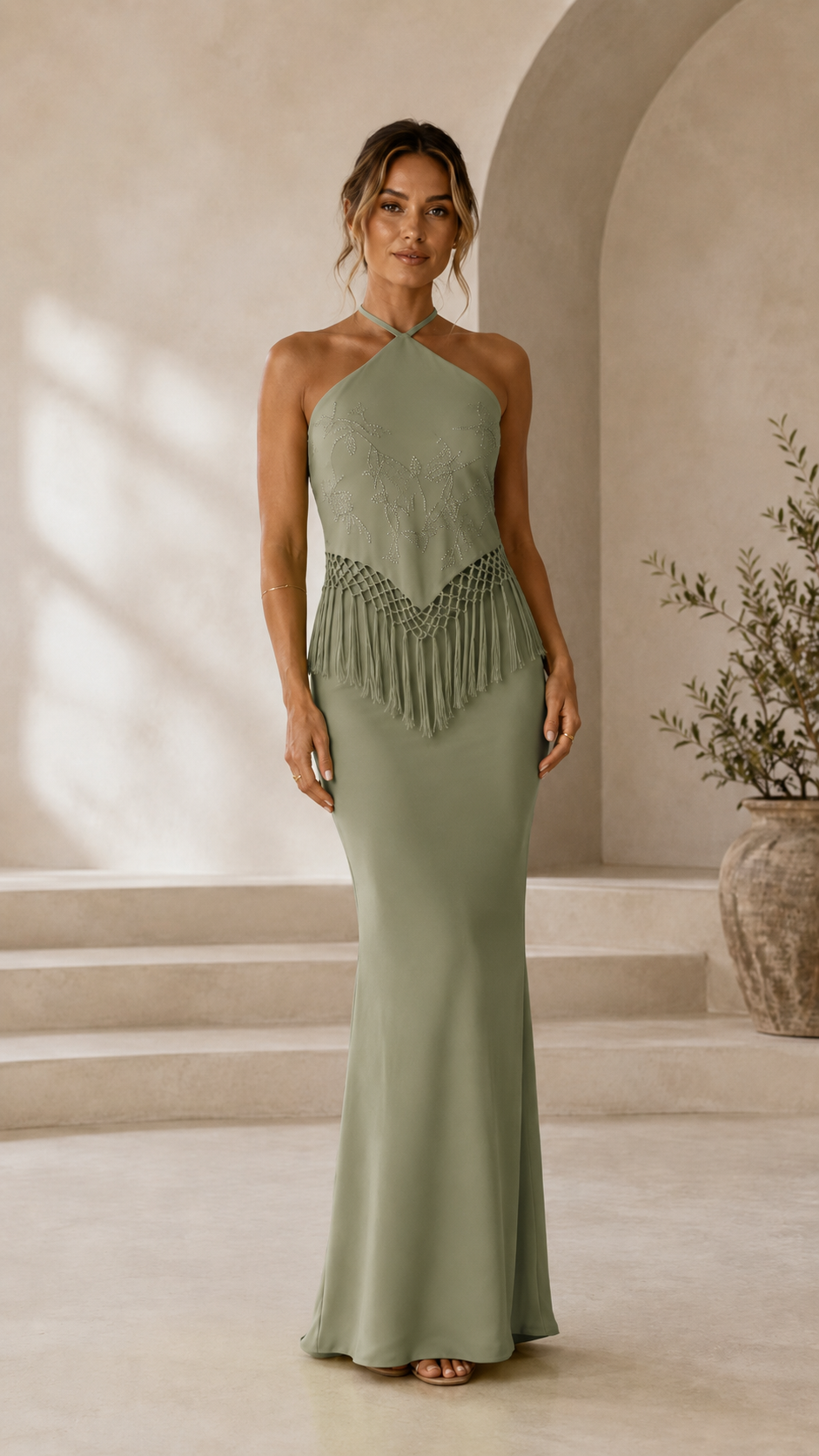 Front view of sage halter mermaid maxi dress with fringe waist detail
