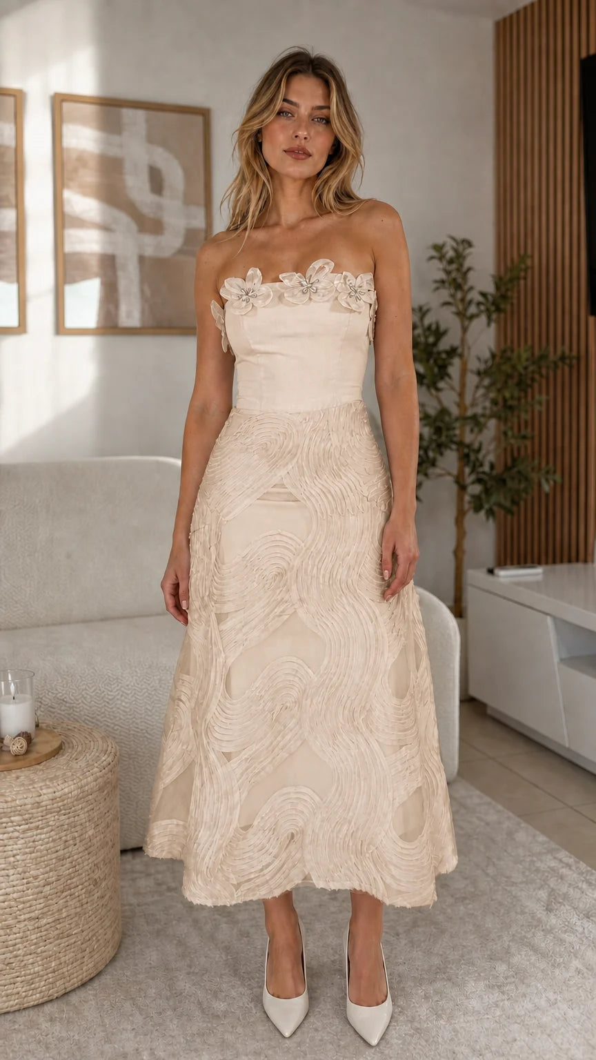 Front view of model wearing champagne strapless midi dress