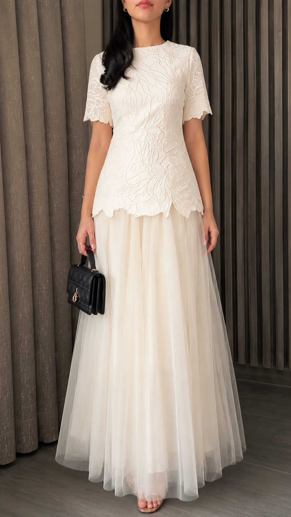 Front view of ivory formal maxi dress with textured bodice and airy skirt