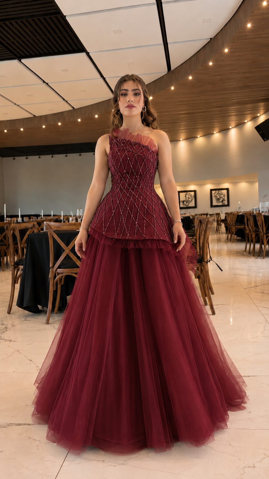 Front view of burgundy one-shoulder ball gown with full tulle skirt