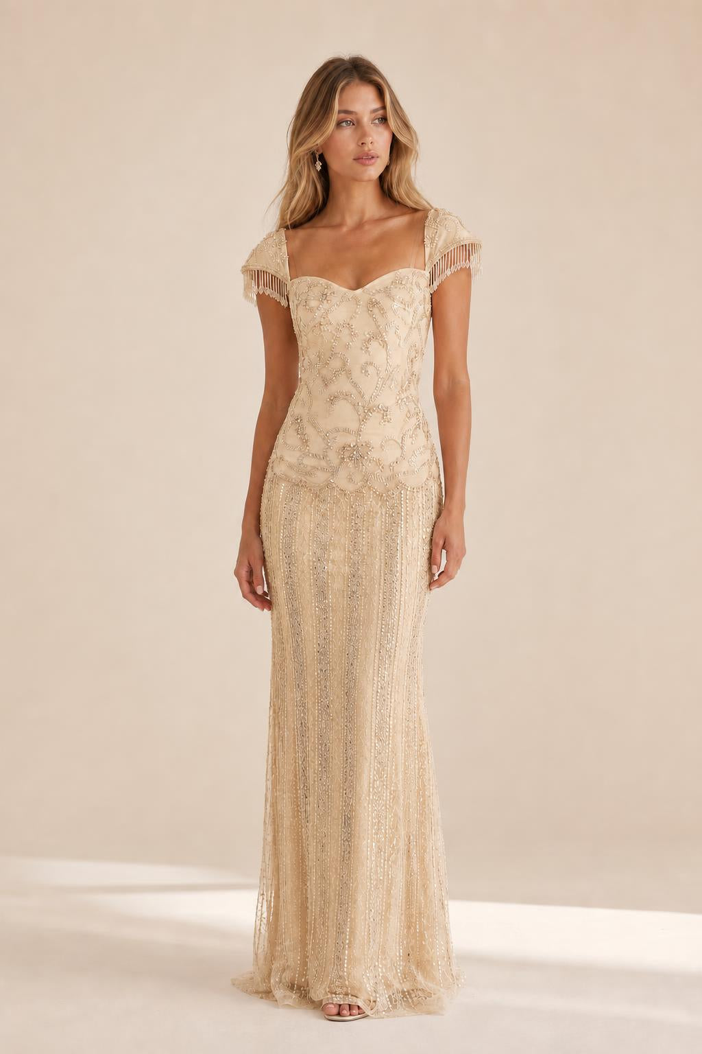 Front view of the champagne beaded evening gown